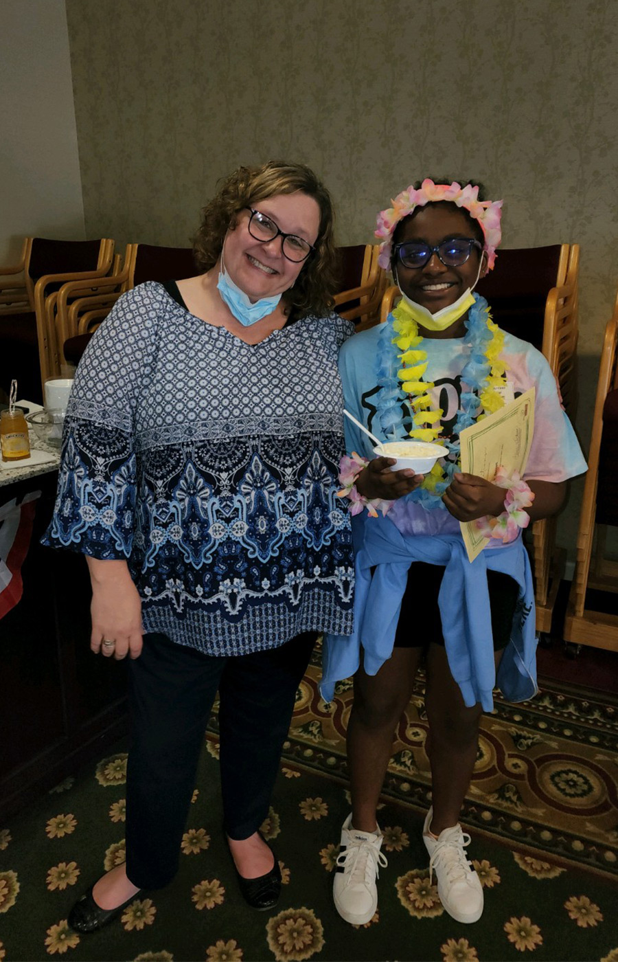 two people smiling for a picture at an ice cream social