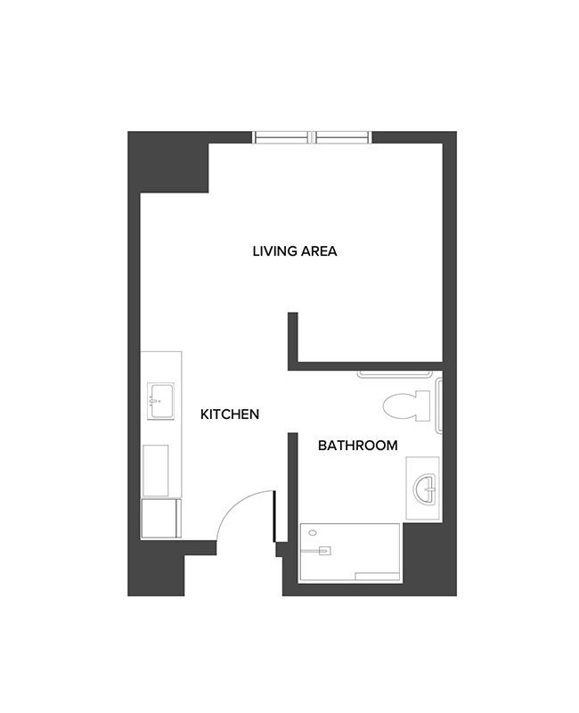 An assisted living studio suite floor plan with an open living/bedroom space and kitchenette.