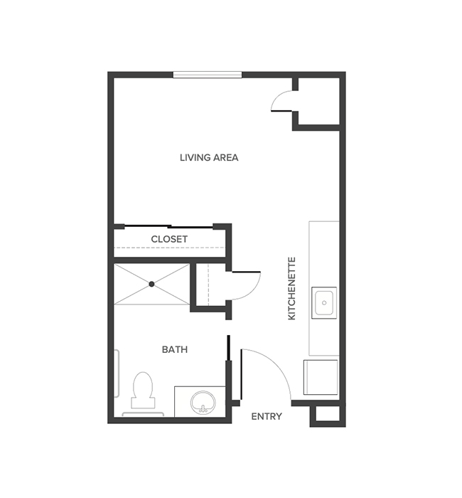 An assisted living studio suite floor plan with an open living/bedroom space and kitchenette.