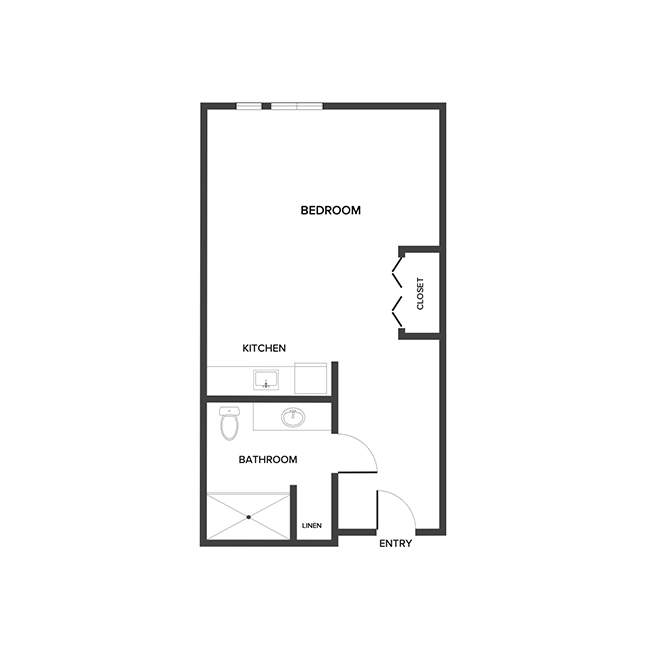 An assisted living studio suite floor plan with an open living/bedroom space and kitchenette.