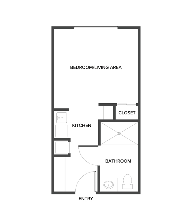 An assisted living studio floor plan with an open living/bedroom space.