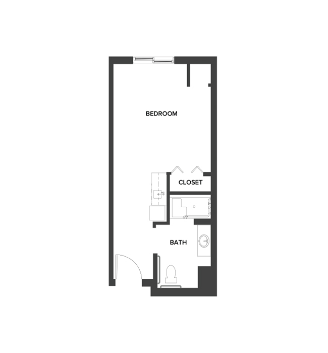An assisted living studio suite floor plan with an open living/bedroom space and kitchenette.