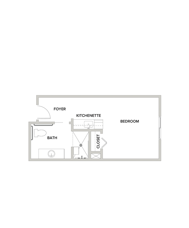 An assisted living studio suite floor plan with an open living/bedroom space and kitchenette.