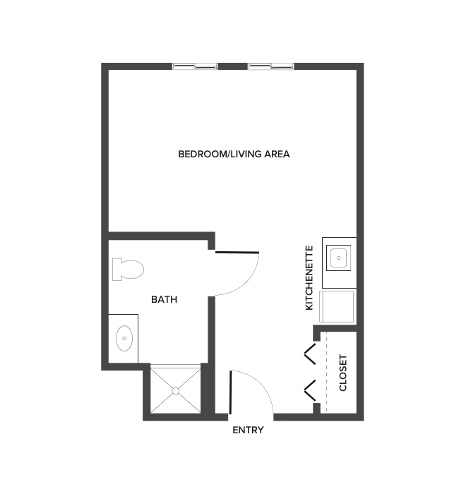 An assisted living studio suite floor plan with an open living/bedroom space and kitchenette.
