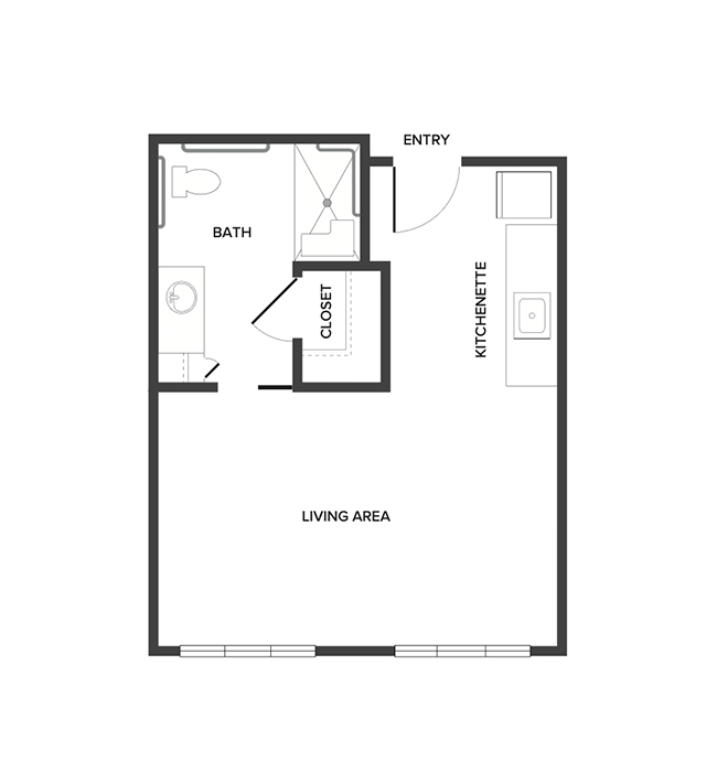 An assisted living studio suite floor plan with an open living/bedroom space and kitchenette.