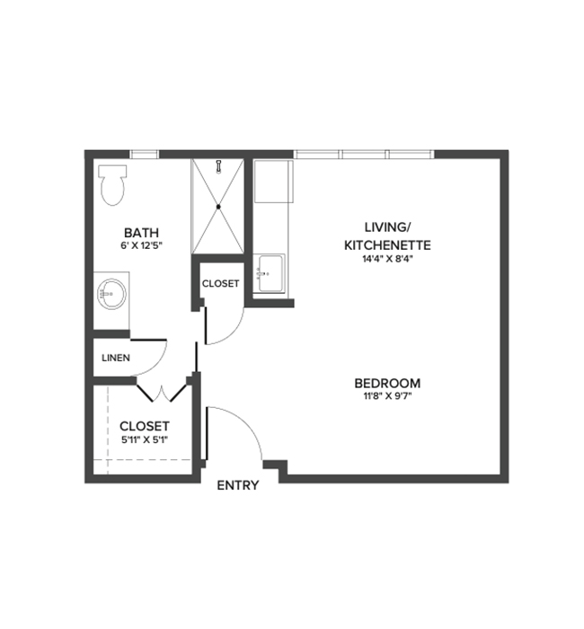 An assisted living studio suite with an open living/bedroom area and kitchenette. 