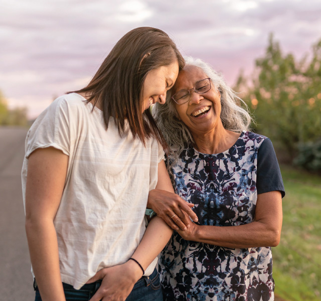 Two people laughing while walking.