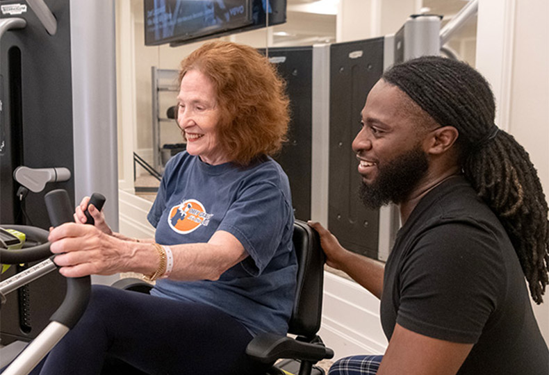 Two people working out in the gym.