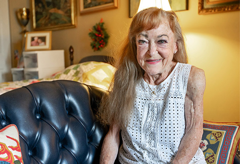 A person sitting on the couch smiling.