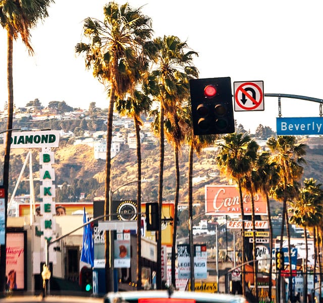 A street in Beverly Hills with a bunch of signs.