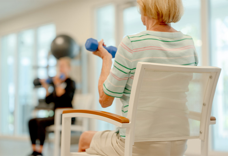A person in a seated fitness class.