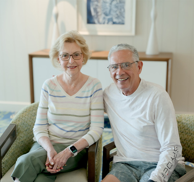 Two people sitting on a couch together.