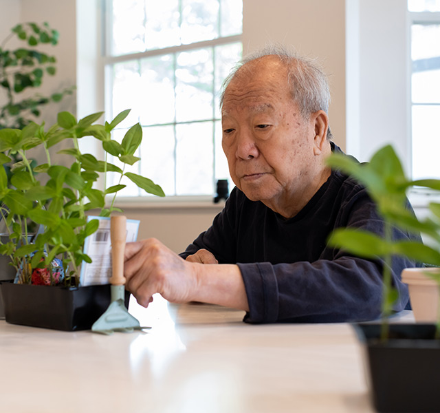 A resident working with plants.