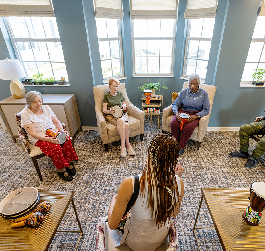 A group of people in a drumming class.