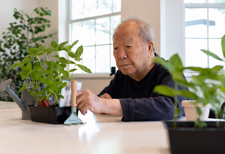 A resident working on the garden plants.