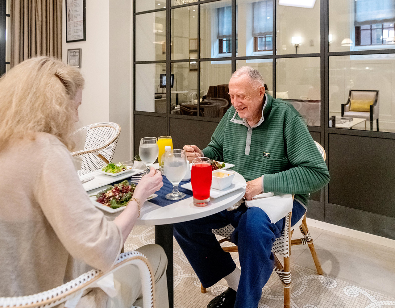 Couple eat lunch in the patio outside.