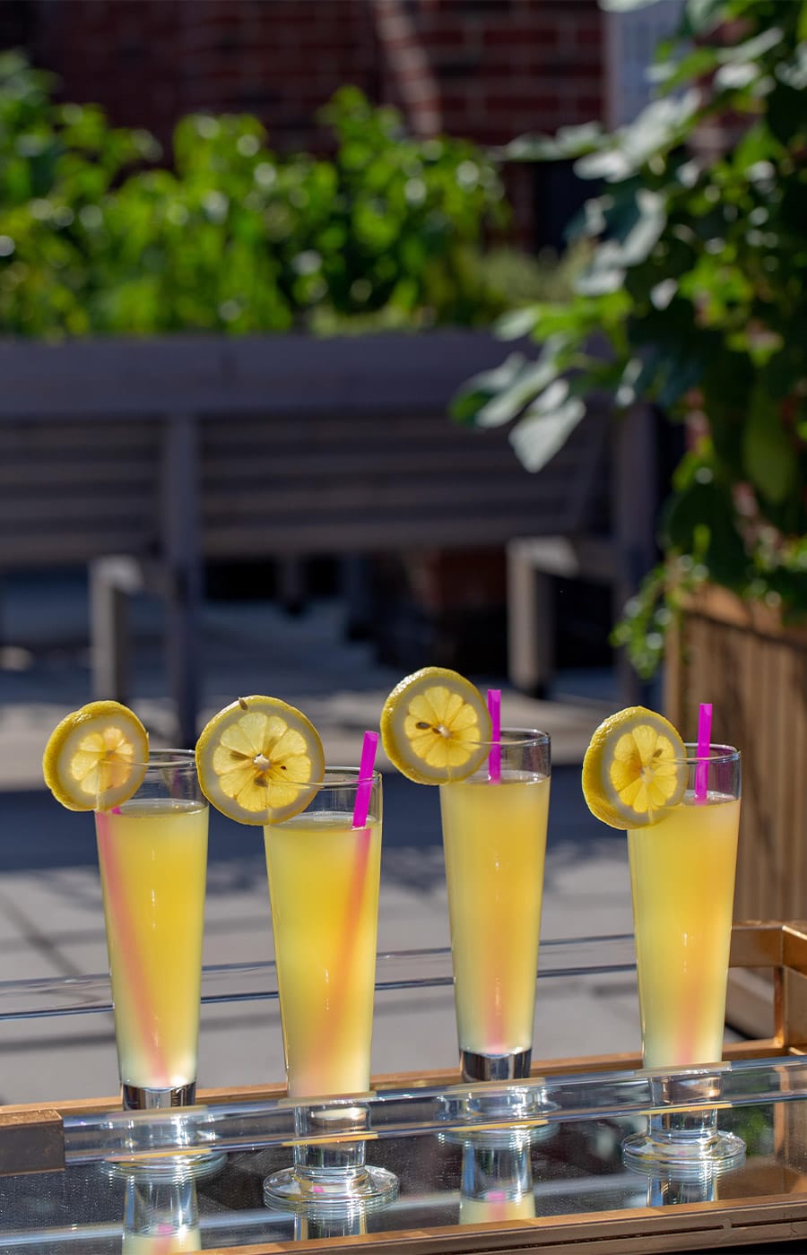 A quartet of beverages on top of the table at the rooftop lounge of The Watermark at Brooklyn Heights.