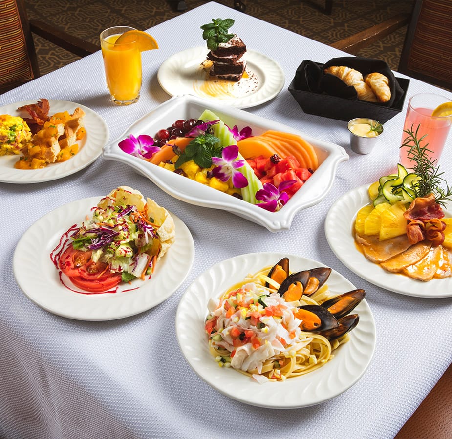 Table with table cloth covered with delicious plates of healthy food.
