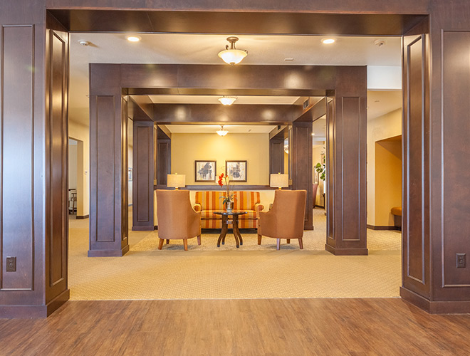 An elegant large hallway facing towards a common seating area.