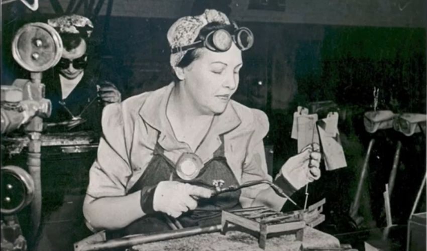 A black and white photo of a woman working nearly a century ago.