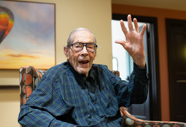 A resident sitting down and waving.