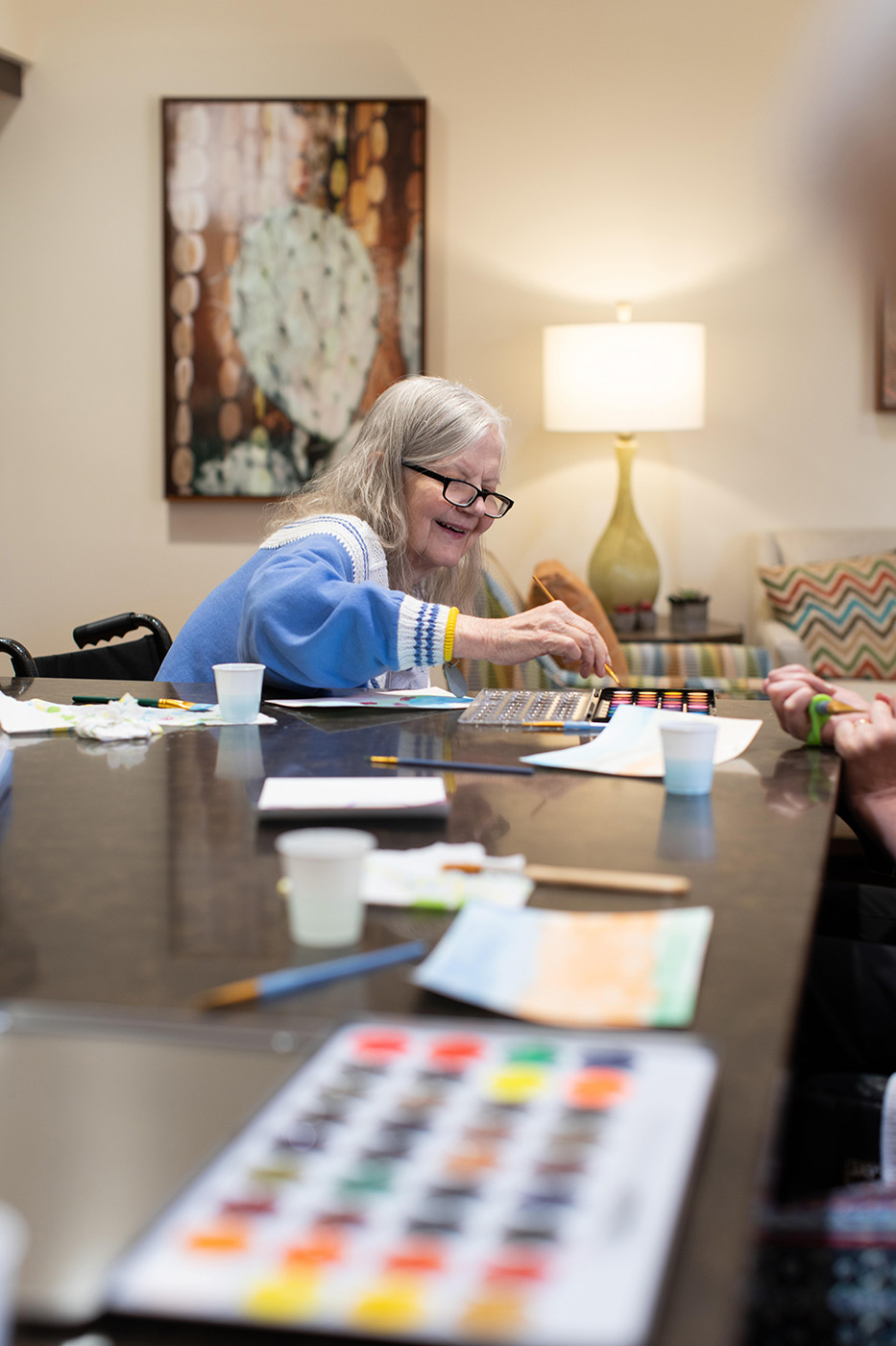 Resident enjoying a painting activity.