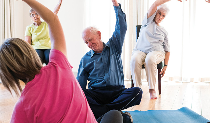 People exercising chair yoga.