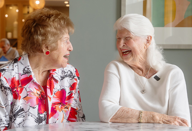 Two people laughing.