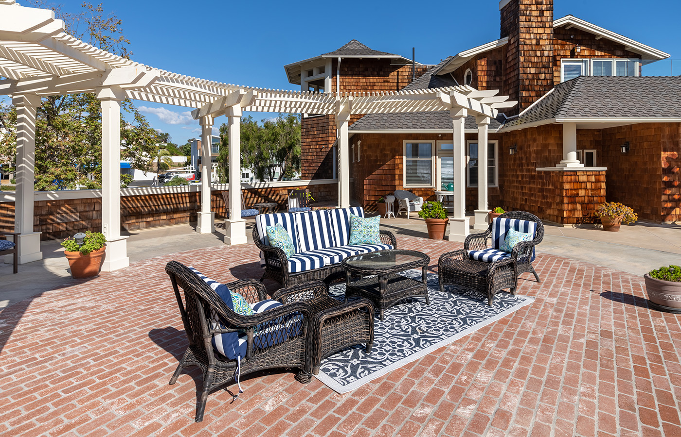 large sunny patio area with elegant patio furniture and navy blue rug