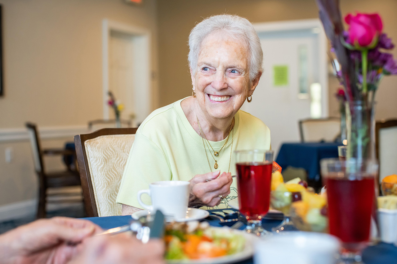 A resident is eating in the dining area.