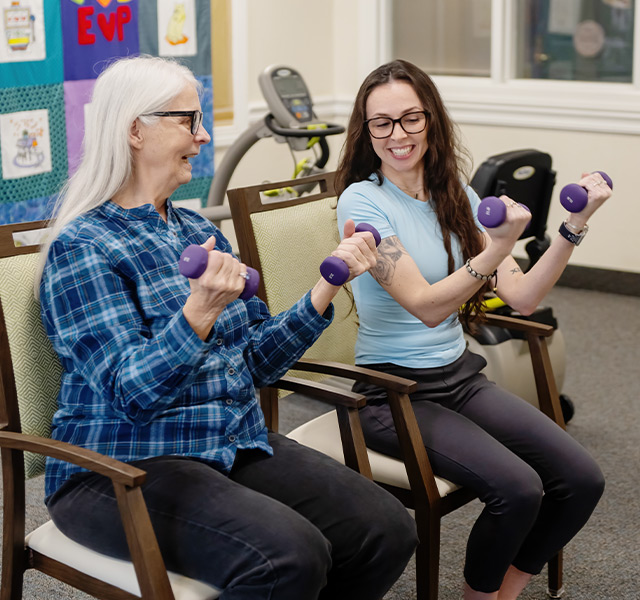 Two people lifting weights.