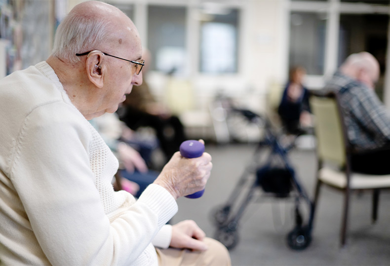 A group of people working out while seated.
