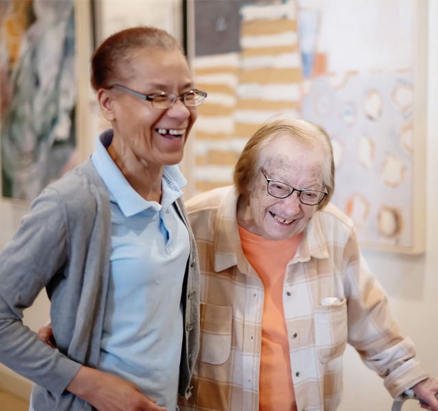 Two people laughing and walking.