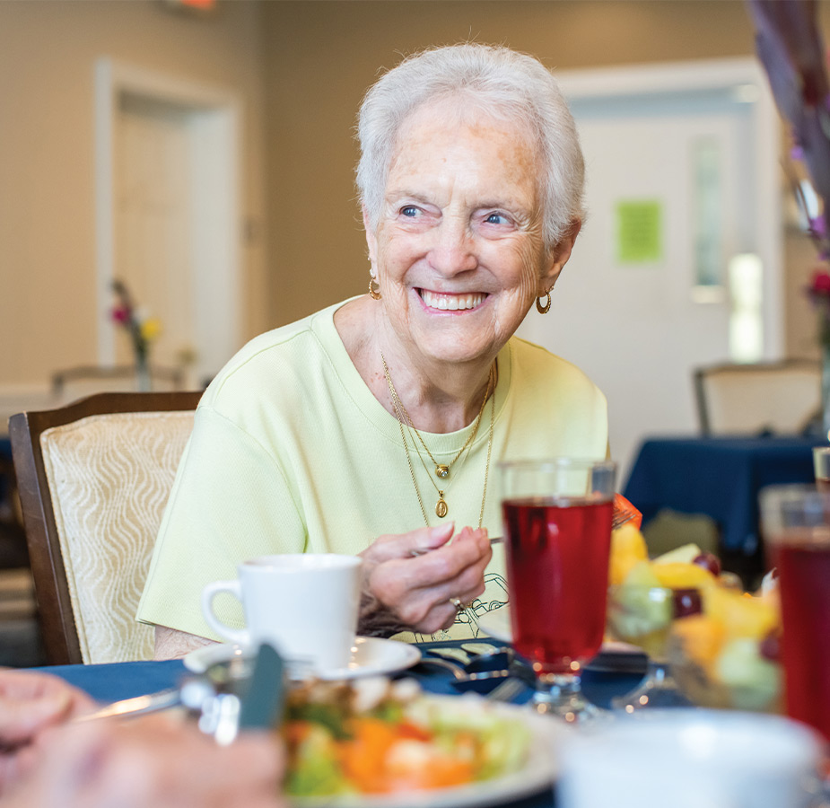 A person sitting at a table eating lunch.