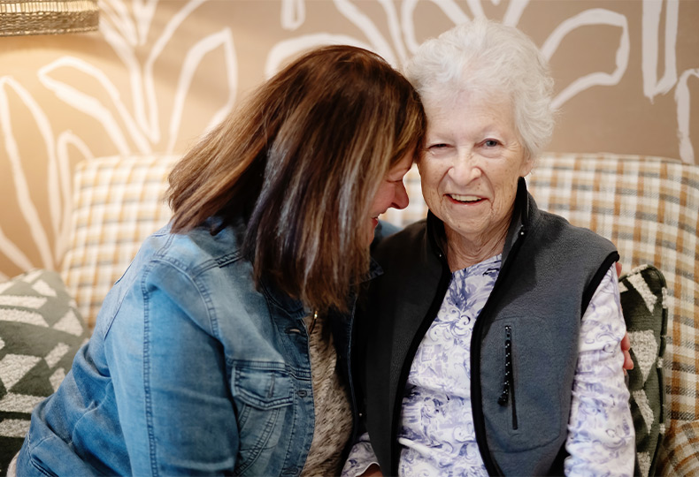 A mother and daughter sitting.