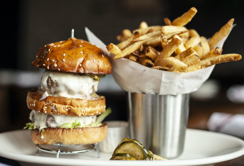 A large burger with fries.