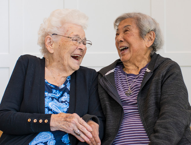 Residents enjoying a laugh and coffee.