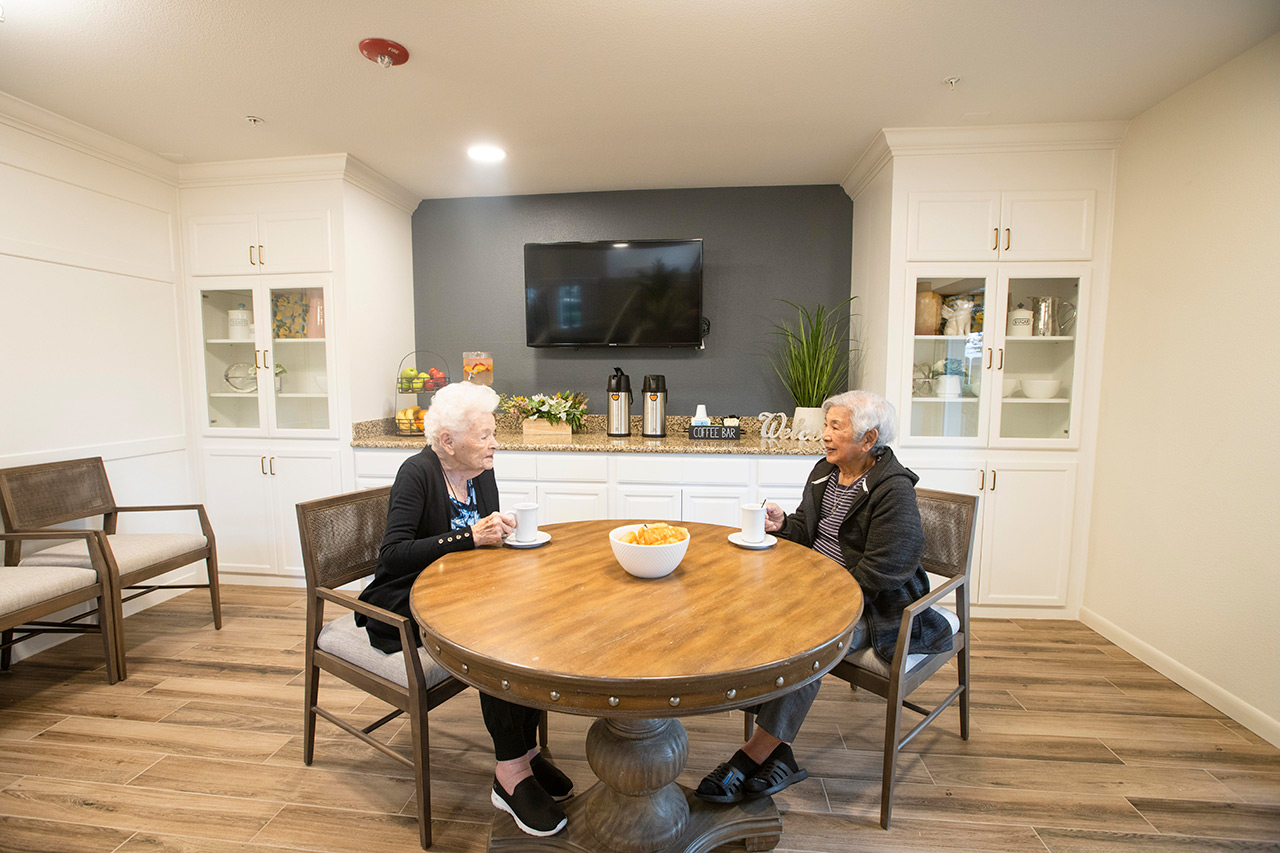 Two residents are in the bistro at Fremont Hills.