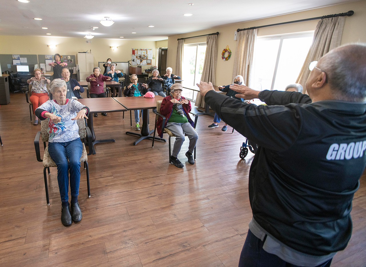 Residents participate in tai chi.
