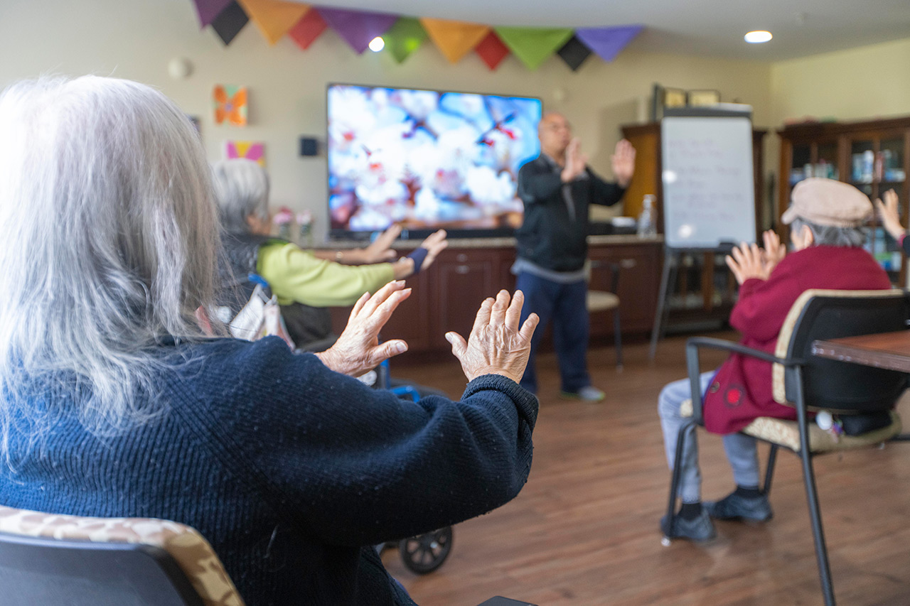 Residents participate in tai chi.