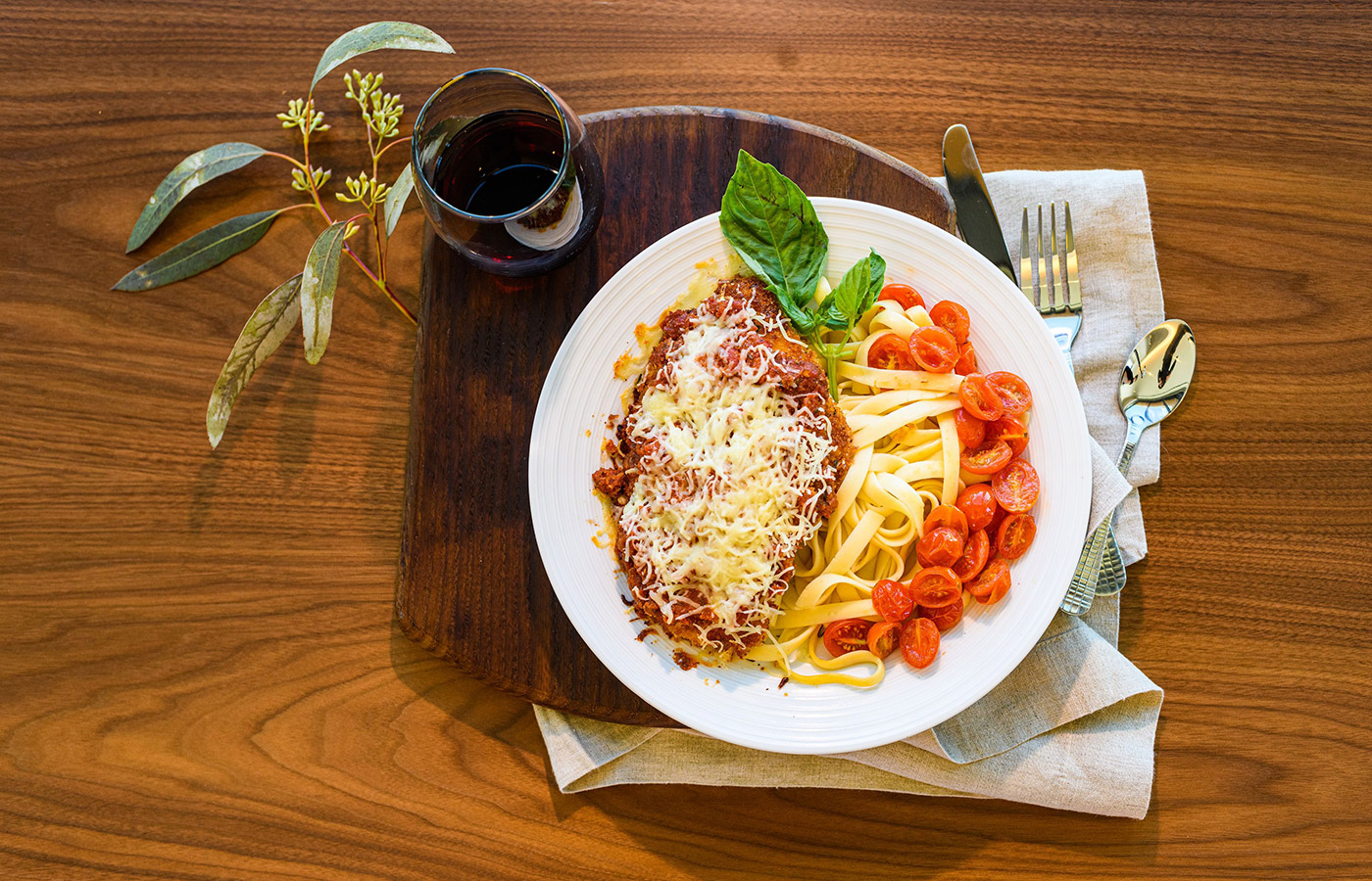 A plate of spaghetti and a glass of wine.