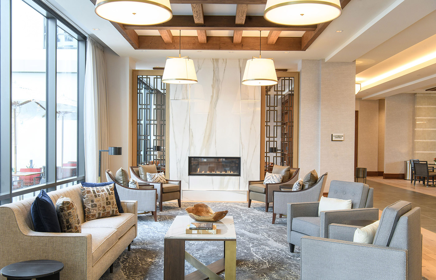 A seating area in front of a fire place.