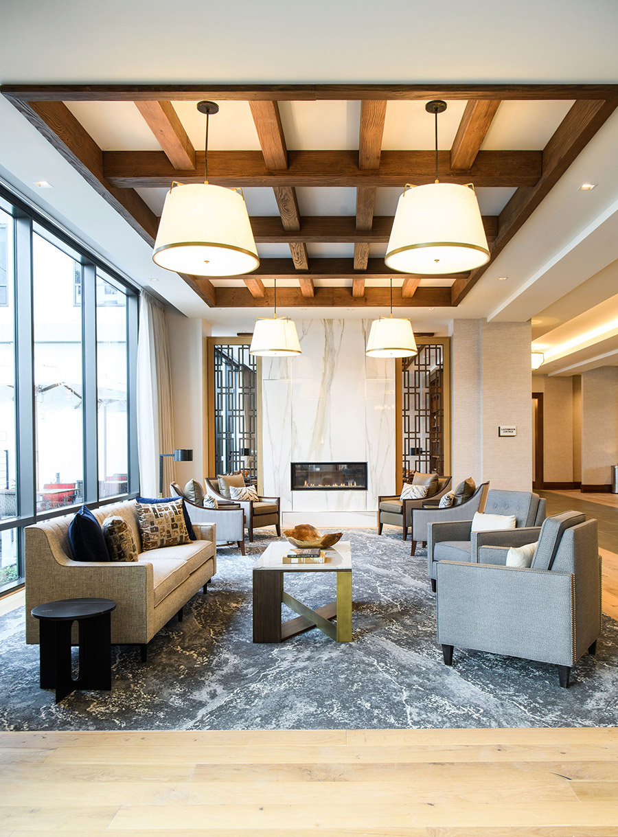 A seating area in front of a fire place.