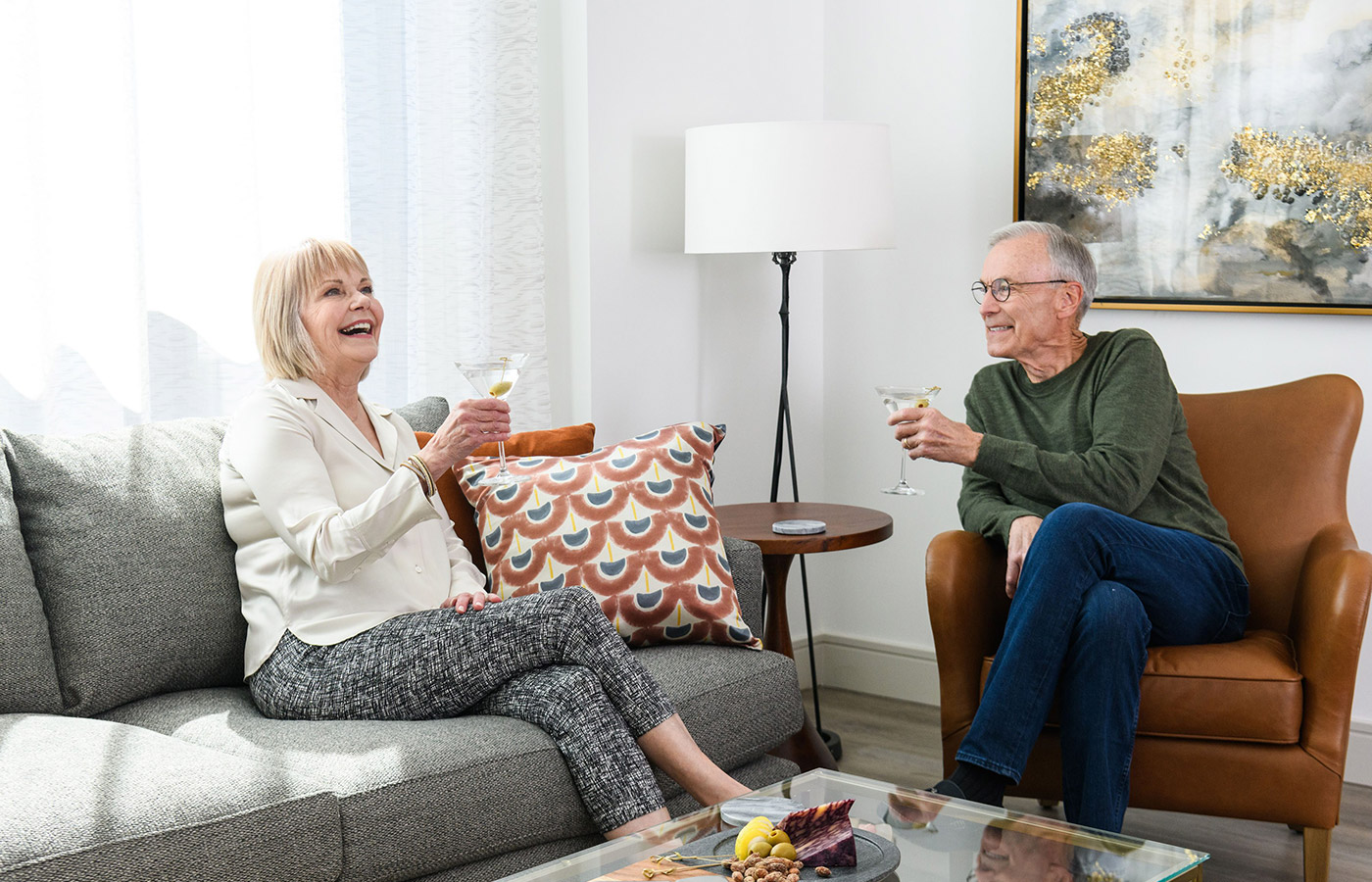 Two residents are sitting, smiling and chatting.