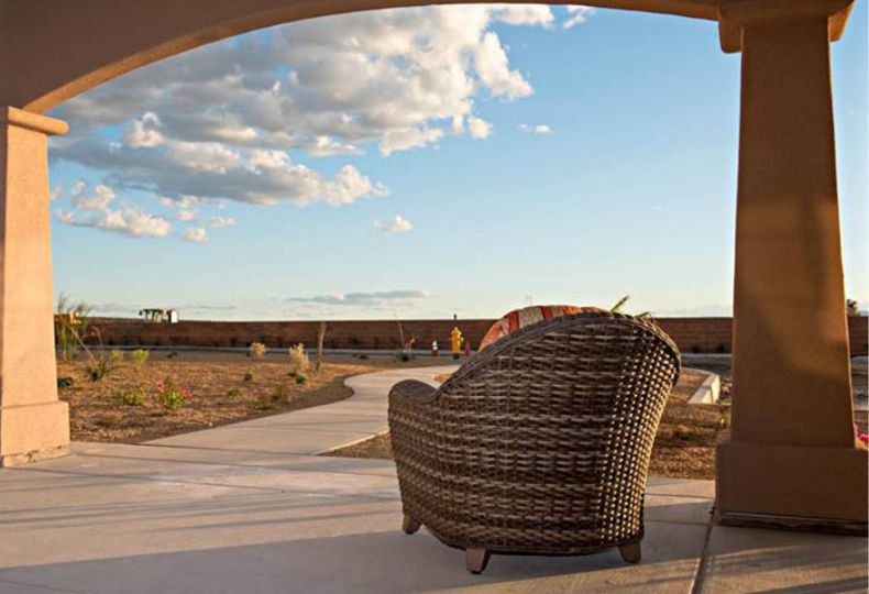 A chair on the patio with views of the dessert.