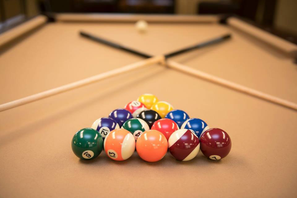 Pool table with balls set for playing.