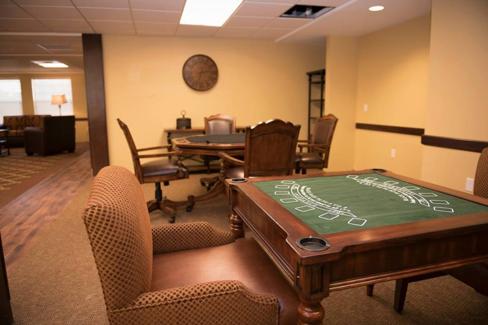 Poker table and chairs in a common area.