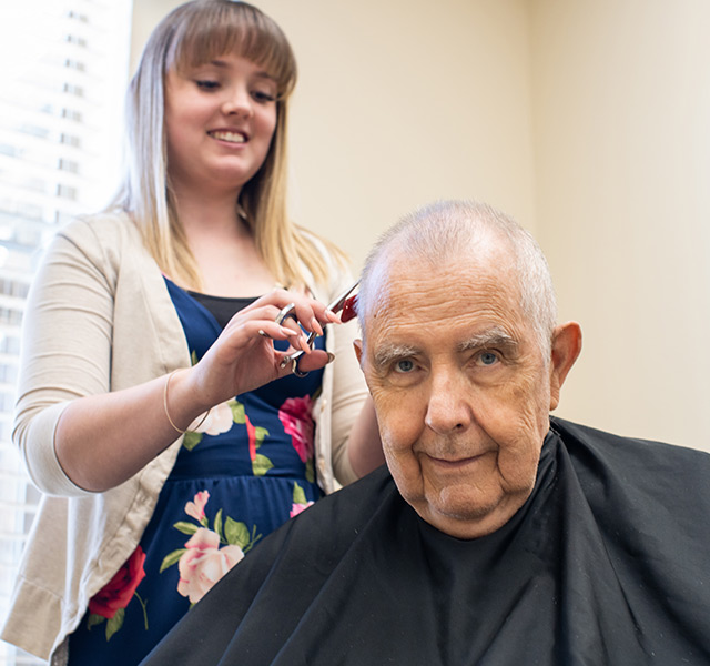 A resident is having their haircut.