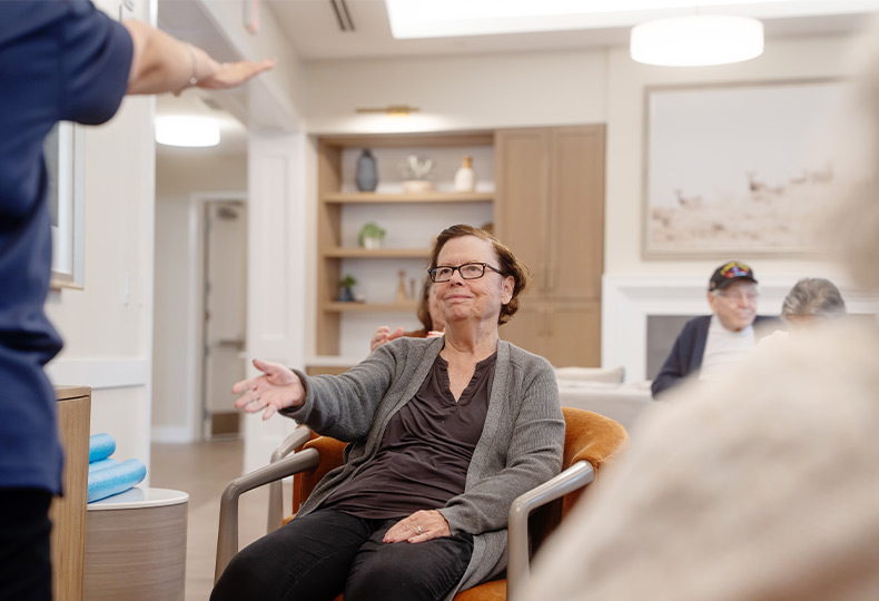 A person seated doing stretches.