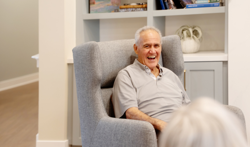 Happy resident sitting in chair.